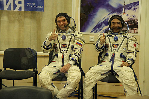 Soyuz TMA-02M crew dons their spacesuits and suit pressurization check before the launch Baikonur cosmodrome tour