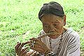 Penan woman playing the nose flute mongurali