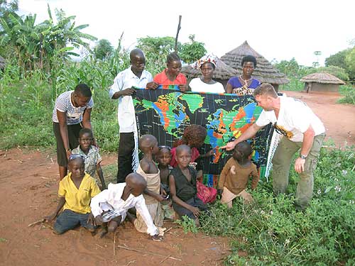 locals from Pokwero Village with World Time Zone kanga after total solar eclipse photo Alexander Krivenyshev WorldTimeZone